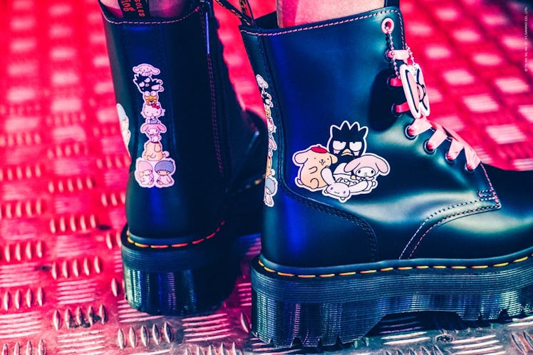 Dr. Martens x Hello Kitty Jadon boots being modeled in an arcade.