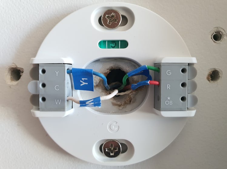 Nest Thermostat mounting plate on a wall.