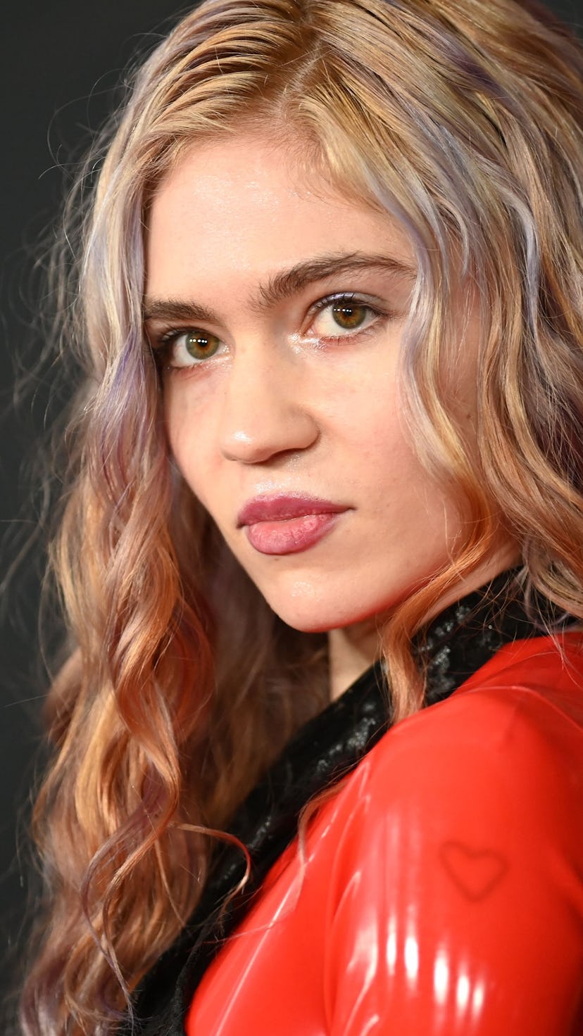Grimes beauty evolution includes this look, featuring blonde hair highlighted with soft pastel shade...