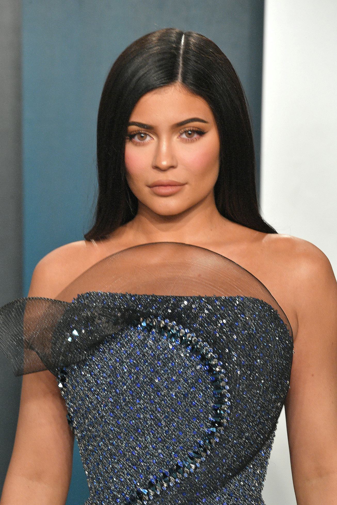 Kylie Jenner on the red carpet with a sleeked middle part.