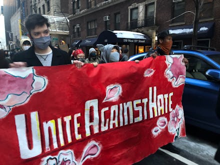 Group of people carrying a "unite against hate" banner at the anti-Asian racism protests in New York