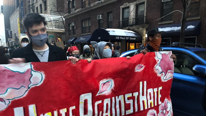 Group of people carrying a "unite against hate" banner at the anti-Asian racism protests in New York