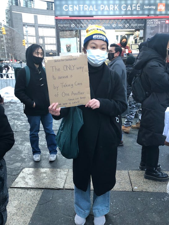 A girl holding a cartoon with "the only way to survive is by taking care of one another" text 