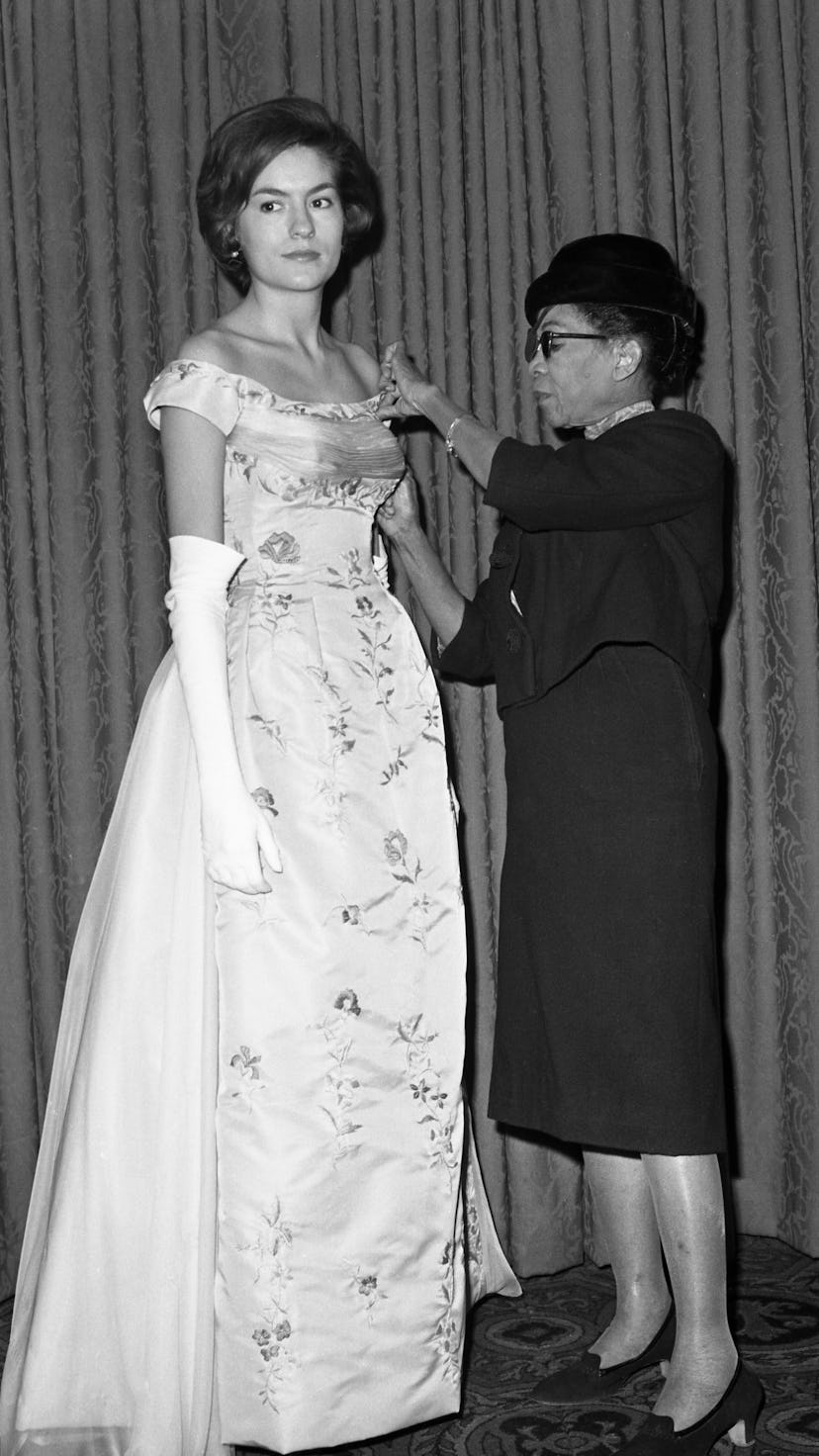Ann Lowe adjusting a gown designed for Alice Baker.