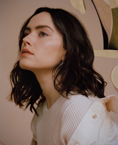 A closeup shot of Daisy Ridley in profile, who wears all white in a TZR cover shoot.