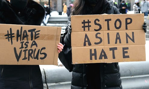 Two women hold signs saying #hateisavirus and #stopasianhate after the covid pandemic triggered a ri...