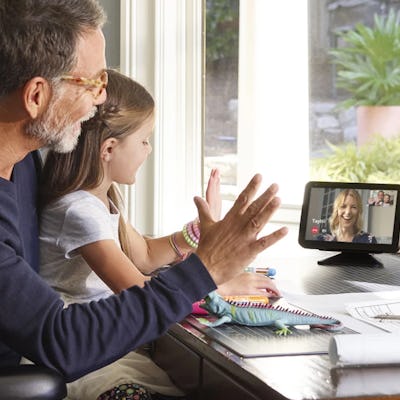 A man and a little girl talk to a woman using an Echo Show.