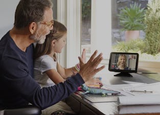 A man and a little girl talk to a woman using an Echo Show.