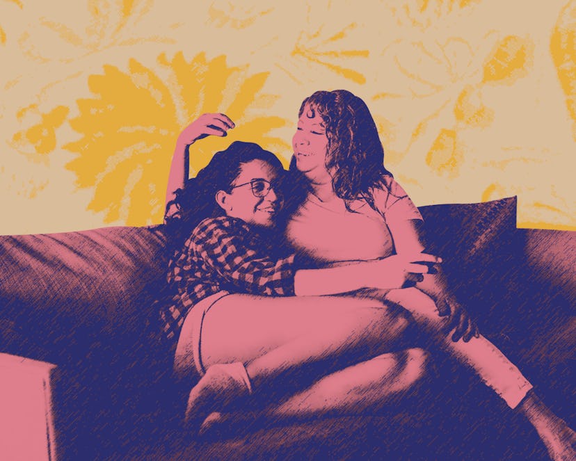Two Latina women sit on a couch after discussing their mental health with their families.