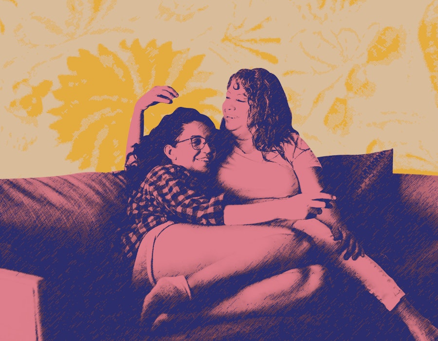 Two Latina women sit on a couch after discussing their mental health with their families.