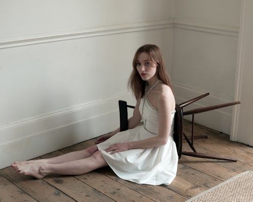 Phoebe Dynevor models a white dress in Self-Portrait's Aututmn Winter 2021 Collection.