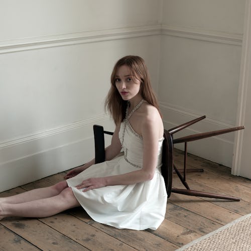 Phoebe Dynevor models a white dress in Self-Portrait's Aututmn Winter 2021 Collection.