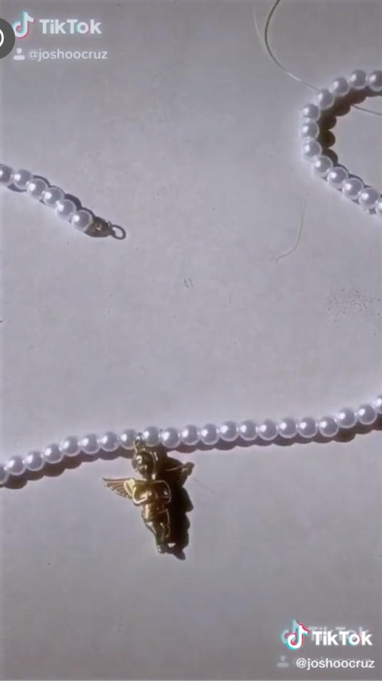 TikToker @joshoocruz makes an opulent pearl necklace by adding a baby angel charm.