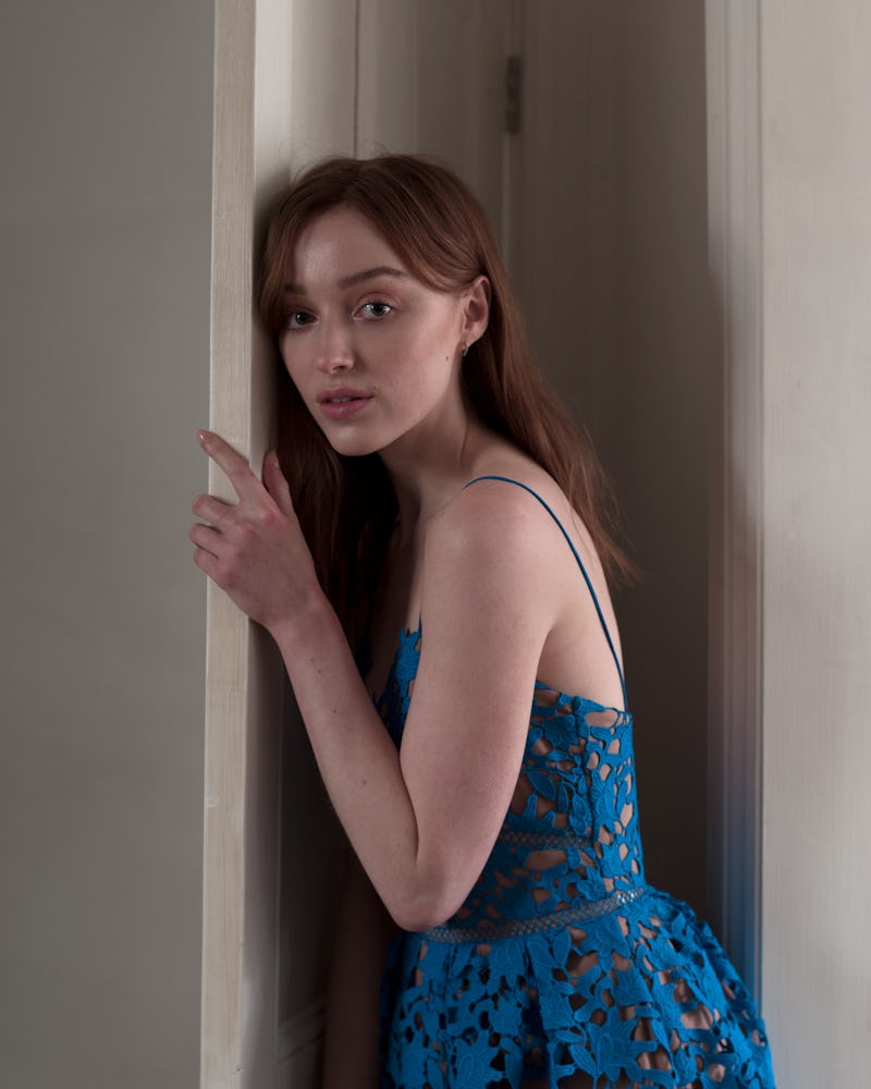 Phoebe Dynevor models a blue lace dress in Self-Portrait's Autum/ Winter 2021 Collection.