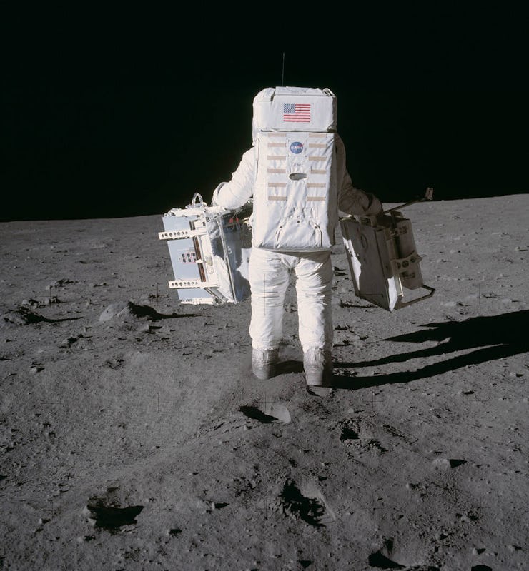 An Apollo astronaut walking across the surface of the Moon.