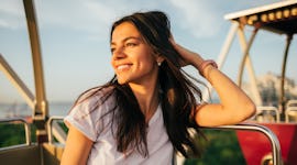 Young woman with her hair blowing in the wind during the fall before posting hair captions, hair cap...