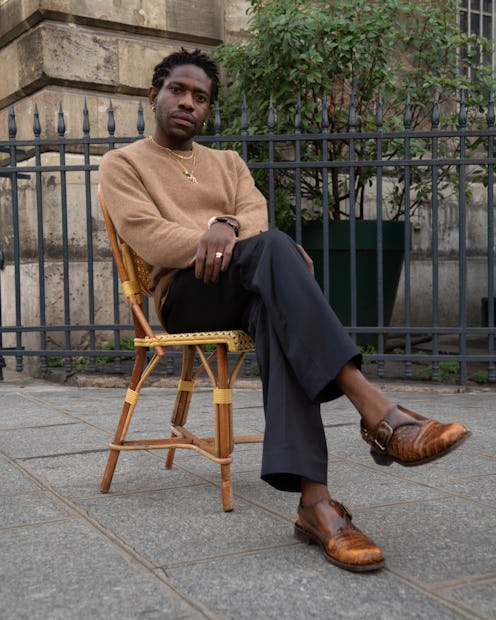 Designer Kenneth Ize poses on chair