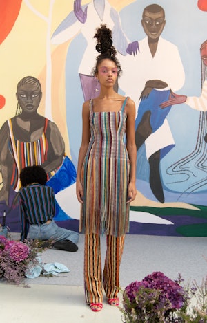 model wearing striped dress and pants