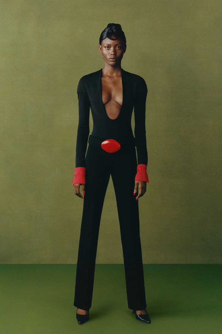A model in a Maximilian black jumpsuit with red accents at the London Fashion Week