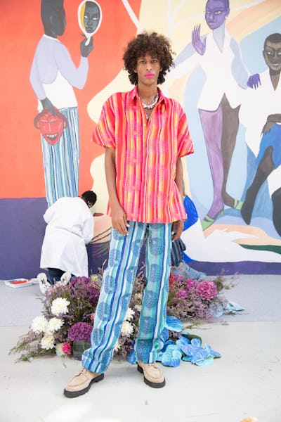 Model wearing pink striped top and blue striped pants by Kenneth Ize