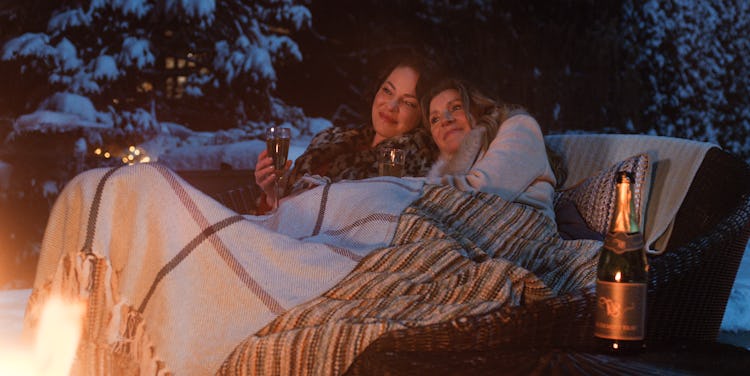 Tully (Heigl) and Kate (Chalke) huddle under blankets by a fire