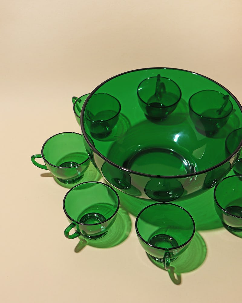 Emerald green punch bowl with matching glasses.