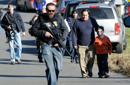 A parent is reunited with a child in Newtown, Connecticut, after the 2012 school shooting at Sandy H...