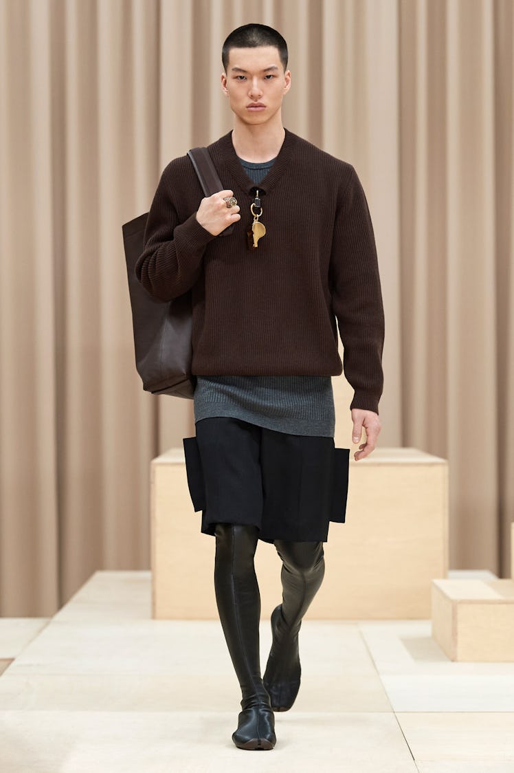 A model in a Burberry brown sweater, grey-black skirt and a black bag at the London Fashion Week