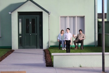 Imogen Poots, Senan Jennings, and Jesse Eisenberg on the front yard of their suburban-style 9 house.