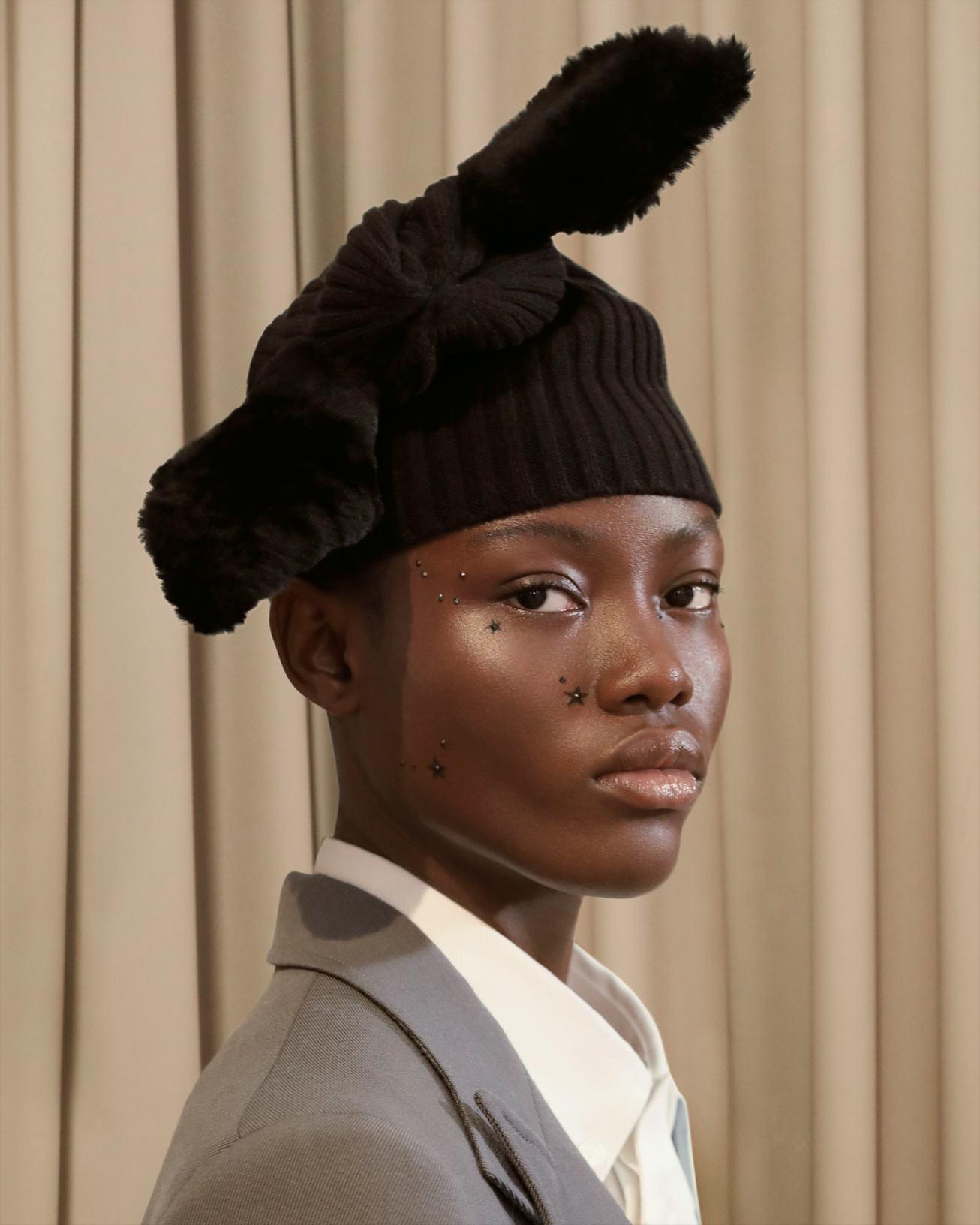 Model poses with face filled with star embellishments