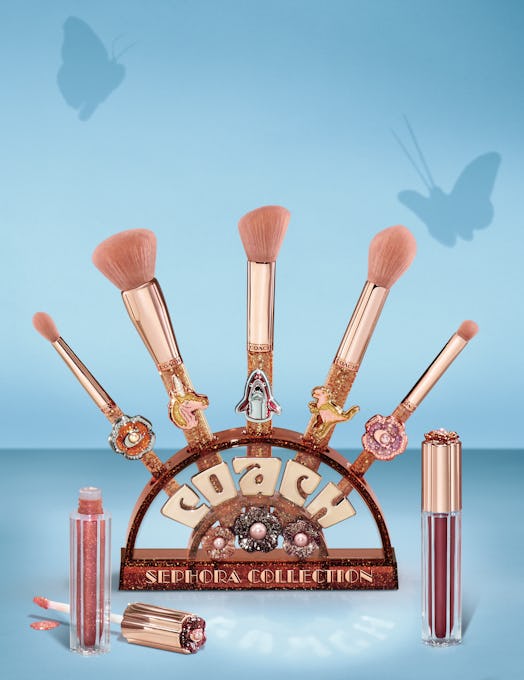 The COACH x Sephora brushes and brush stand accompanied with two of the lipglosses.