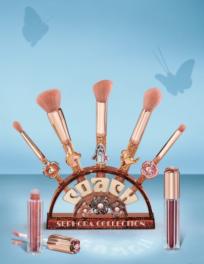The COACH x Sephora brushes and brush stand accompanied with two of the lipglosses.