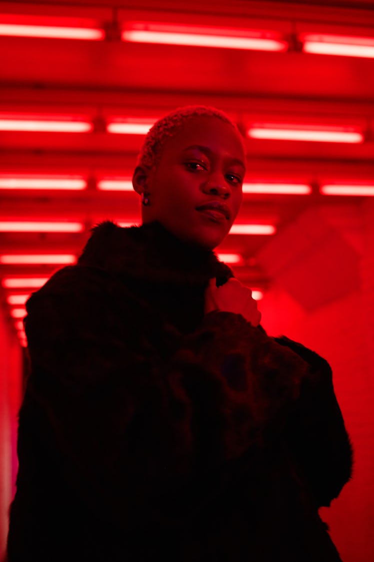 Portrait of young woman in neon light