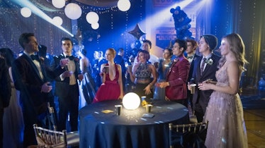 The 'Riverdale' crew gathers around a table at a school dance.