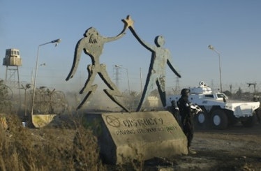A statue from District 9 showing an alien and humand holding hands.