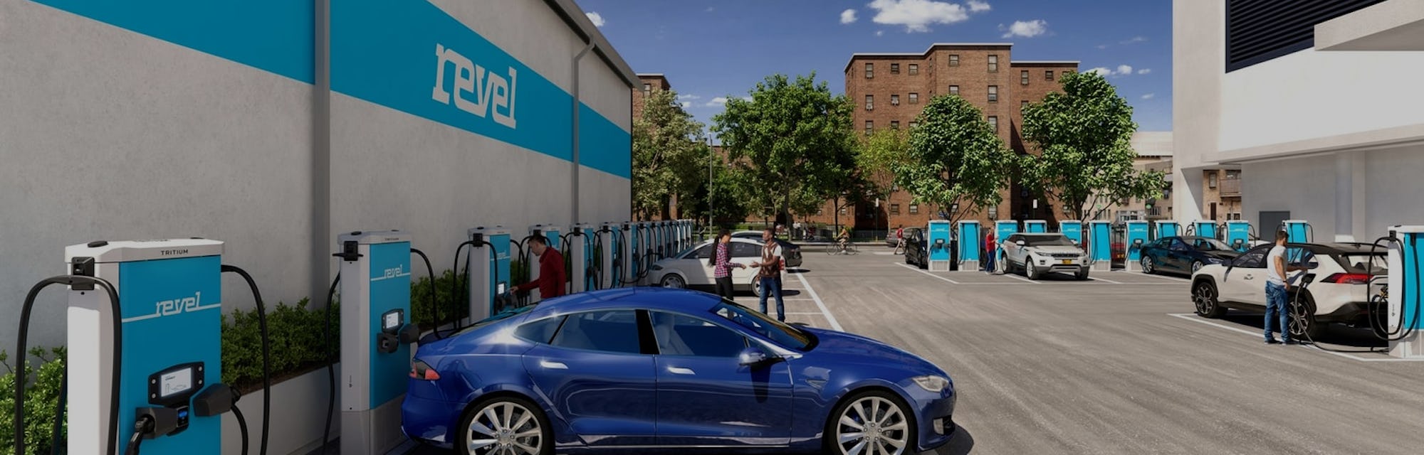 A blue Tesla sits docked at a Revel electric charging station.