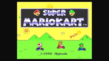 The opening screen for Super Mario Kart, featuring from left to right Toad, Princess Peach, and Luig...