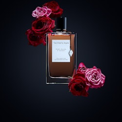 The   Collection Extraordinaire Rose Rouge Van Cleef & Arpels bottle surrounded by roses