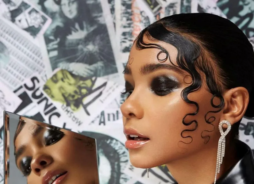 Got2be model with dark eye makeup and artful edges.