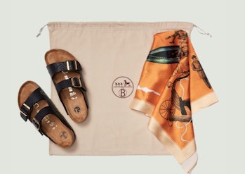 Black Birkinstock sandals and orange Hermés scarf