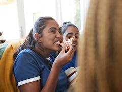 Young women eating pizza