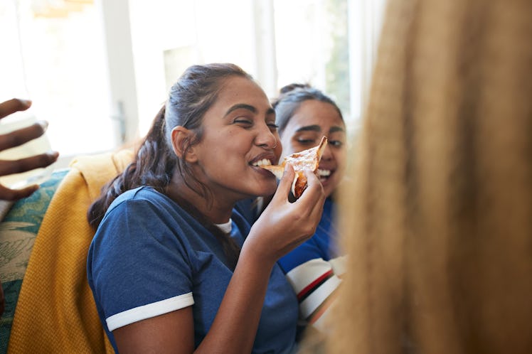 Young women eating pizza