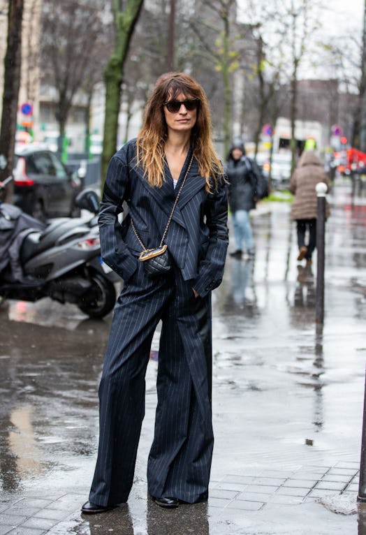 Caroline de Maigret wearing a navy blazer and navy wide leg chino pants