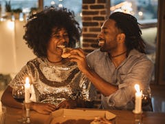 Couple eating pizza on date night at home