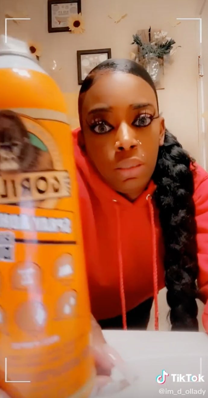 Tessica Brown holds a bottle of Gorilla Glue, a product she used on her hair