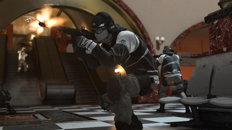 A character in League Play in Call of Duty: Cold War crouching on the floor with a gun