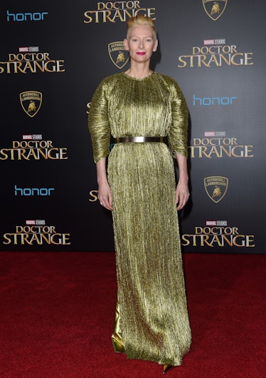 Tilda Swinton attends the 'Doctor Strange' Premiere wearing a golden colored dress