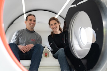 Josh Giegel and Sara Luchian sitting inside a Virgin Hyperloop passenger pod.