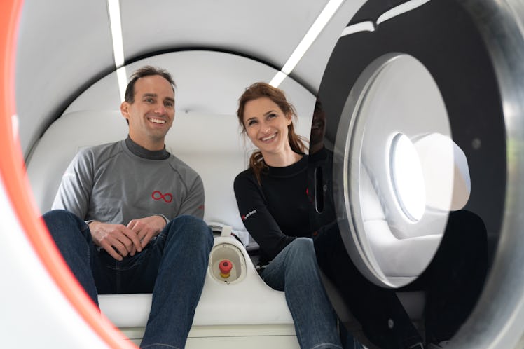 Josh Giegel and Sara Luchian sitting inside a Virgin Hyperloop passenger pod.