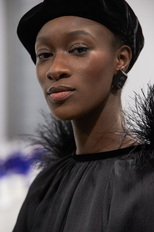 Model poses backstage at the Giorgio Armani Fall/Winter 2021 show during Milan Fashion Week.